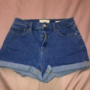 Pacsun deep blue “shortie” shorts cuffed.